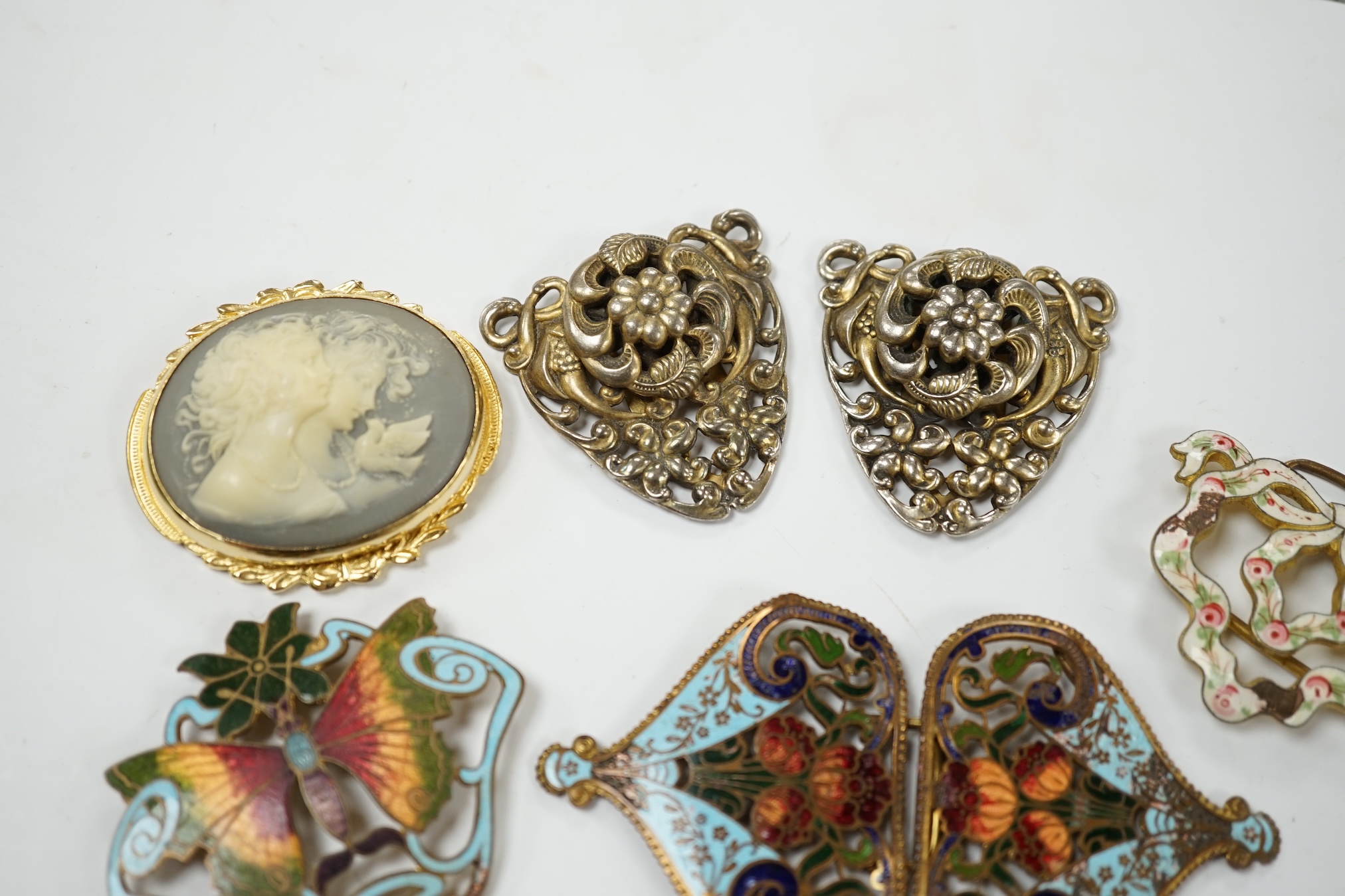 A Mexican Los Castillo sterling and cabochon amethyst set foliate brooch, 60mm, a small collection of base metal and cloisonné enamel belt buckles and a cameo brooch. Condition - poor to fair